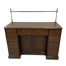 George III mahogany sideboard, raised brass rail over rectangular top with moulded edge, fitted with an assortment of eight drawers including a cellarette function, surrounding a recessed double cupboard, on skirted base