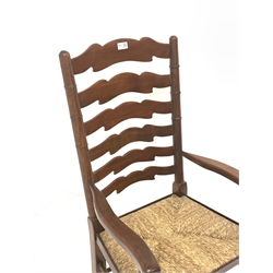 Late 20th century mahogany farmhouse style carver armchair, waved ladder back and rush seat, total width - 56cm
