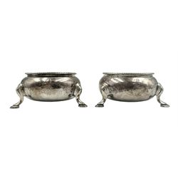 Pair of Victorian silver circular salts with bead edge decoration on shaped supports London 1864 Maker Andrew Crespel and Thomas Parker and set of four William IV silver salt spoons with shell finials and oak tree crest Glasgow 1837 Maker Robert Gray & Son
