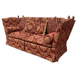 A large Knole drop arm two seater sofa, upholstered in red floral damask fabric, with squab and baluster cushions (W251cm, H108cm, D97cm)