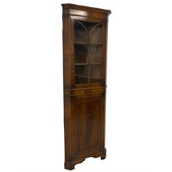 Georgian design mahogany corner display cabinet, moulded cornice over plain frieze, the upper section enclosed by astragal glazed door, panelled cupboard below with applied mouldings, on ogee bracket feet