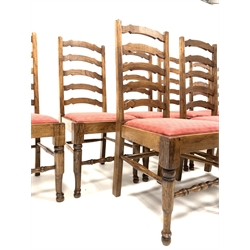 Set of twelve oak waved ladder back dining chairs with drop in upholstered seat pads and turned front supports and stretchers, W50cm