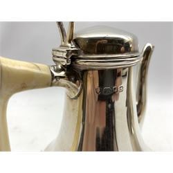 Pair of silver cafe au lait pots of Art Deco design of spreading form with ivory handles on pierced angular feet H15cm London 1932 Maker Edward Barnard & Sons 21oz gross 