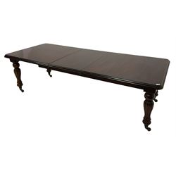 Victorian design mahogany extending dining table, rectangular top with moulded edge, raised on turned and lobed vasiform supports terminating in brass cups and castors, with additional leaf