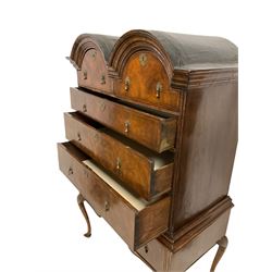 Early 18th century walnut double-domed chest-on-stand, the stepped moulded cornice above two arched short and three long graduating drawers, each with feather stringing, the base fitted with three short drawers over a shaped apron, raised on cabriole supports terminating in pointed pad feet
Provenance: From the Estate of the late Dowager Lady St Oswald