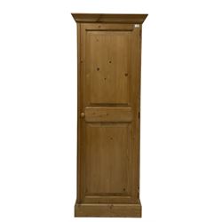 Waxed pine cupboard, fitted with single door, opening to reveal one fixed shelf over one hanging rail, raised on a plinth base