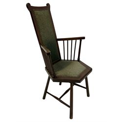 Arts and Crafts Liberty design mahogany framed elbow chair, high back and seat upholstered in foliate patterned laurel green fabric with studwork border, spindle arm supports, raised on splayed supports united by H-stretcher