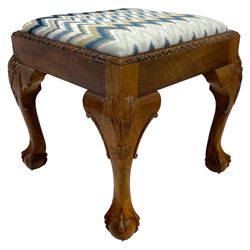 Georgian design square walnut stool, drop-in seat upholstered in patterned blue fabric, carved egg and dart edge raised on cabriole supports with moulded foliate and scroll decoration, on ball and claw feet