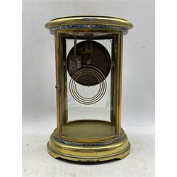 An early 20th century French oval four glass clock with cloisonne decoration, four bevelled convex glass panels (two missing) and a two-file mercury pendulum (one file broken), gilt chapter ring with upright Arabic numerals, minute markers and gilt fleur de lis hands, dial with enamel central boss inscribed JD Williams & Son, Paris, with an eight-day rack striking movement striking the hours and half hours on a coiled gong, No key.


