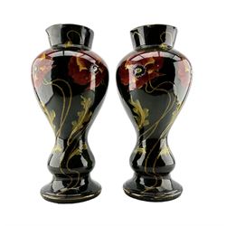 Pair of large Art Nouveau pottery vases, each painted with stylized poppies, over a deep brown and green glaze, unmarked, but in the style of Weller Pottery, H42cm