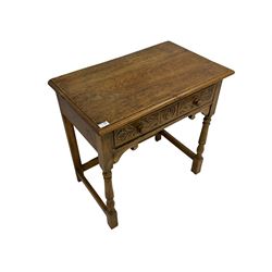 20th century oak side table, rectangular top with moulded edge, fitted with single drawer carved with roundall and foliate decoration, raised on turned supports united by stretcher