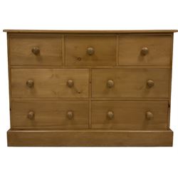 Pine multi-drawer chest, fitted with three short and four long drawers, raised on a plinth base