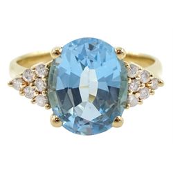 14ct gold oval topaz ring, each side set with six round brilliant cut diamonds, stamped 585