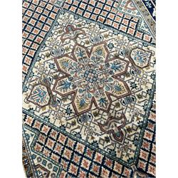 Persian Hamadan blue and sage green ground rug, central floral medallion in pale ground lozenge, the field decorated with stylised leaf motifs, five band border decorated with geometric patterns and stylised plant motifs