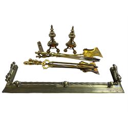 19th/ early 20th century brass fire curb L137cm, two sets of brass implements and a pair of brass fire dogs 