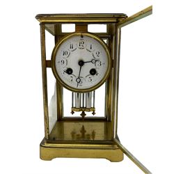 An early 20th century French Four Glass clock of small proportions c1910, with an eight-day striking movement , striking the hours on a bell, with an enamel dial with upright Arabic numerals and quarter hour minutes, minute track, steel moon hands, decorated with garland swags of flowers, twin file faux mercury pendulum.




