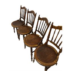 Ibex - set four dining chairs, the cresting rail with carved fruit and foliate design over spindle back and circular seats, raised on turned supports 