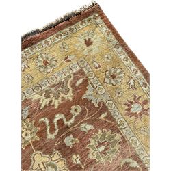 Persian design beige ground rug, Zeigler style with stylised plant decoration, pale ground border decorated with flower heads