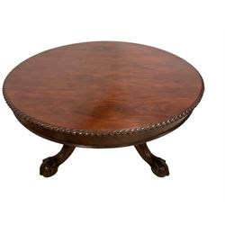 Mid-19th century Irish mahogany centre table, the circular top with gadroon moulded edge and banded frieze, raised on large turned pedestal with carved foliate insets, the large cabriole supports with moulded acanthus leaf decoration terminating in ball and claw feet with castors 