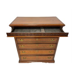 Early 19th century oak chest, rectangular mahogany crossbanded top with moulded edge, over dentilled cornice and blind fretwork frieze drawer, fitted with three short drawers over three long graduating drawers, each with mahogany crossbanding and ebony and satinwood stringing, flanked by fluted pilaster columns, raised on shaped bracket feet