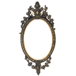 Late 19th century giltwood and gesso oval wall mirror, with bevelled plate enclosed by floral moulded frame and surmounted by floral pediment, 93cm x 47cm