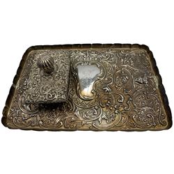 Late Victorian rectangular silver dressing table tray heavily embossed with masks, scrolls and flower heads, the cartouche engraved with a monogram 27cm x 17cm London 1895 Maker William Comyns & Sons and a silver mounted desk blotter Birmingham 1900 Maker Henry Matthews (2)