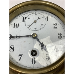 Early 20th century brass bulkhead clock, white enamel dial with Arabic chapter ring and subsidiary seconds hand, (D19cm) together with an early 20th century aneroid barometer in carved walnut case (D19cm) and a brass cased aneroid barometer (D11cm)