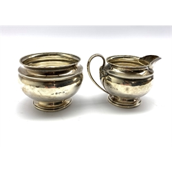 Silver circular sugar bowl on a short pedestal foot and matching cream jug Birmingham 1920 6.49oz