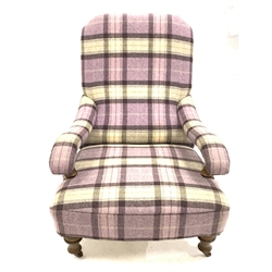 Victorian style low armchair upholstered in chequed wool, with open arms raised on turned oak front supports with castors