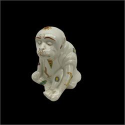 Unusual 19th century creamware model of a seated monkey, wearing robes and decorated with astrological symbols, base marked 2011, H10cm