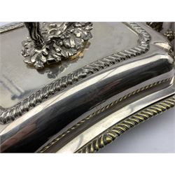 A Victorian silver-plated twin handled entree dish, the cover having engraved boar crest, acanthus leaf moulded handle, gadroon borders, with liner on compressed bun supports L38cm, together with two similar entree dishes, one bearing a rampant lion crest (3)