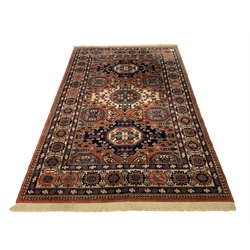 Persian Kadjar design ground rug, repeating lozenge and gul motif on red field, stylised floral decoration to border