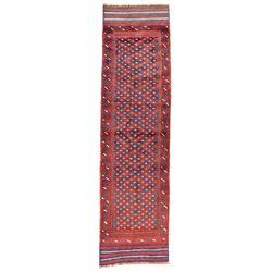 Meshwani indigo and maroon runner rug, the field decorated with connecting lozenges with ivory details, the border with stylised spiral waves, the short edges with indigo stripes