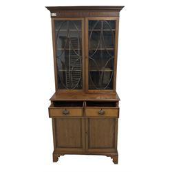 Early 20th century inlaid mahogany bookcase on cabinet, projecting dentil cornice over two astragal glazed doors enclosing adjustable shelves, crossbanded and ebony-strung top, fitted with two drawers over two panelled cupboard doors, on bracket feet