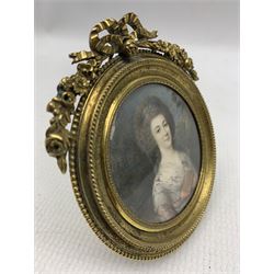 French School (Early 19th century): Half length miniature portrait on ivory of a lady, wearing a tulle shawl and holding a book, signed Bordes and indistinctly dated, in a circular gilt metal easel frame, with beaded border and ribbon cresting, D6.5cm. This item has been registered for sale under Section 10 of the APHA Ivory Act
