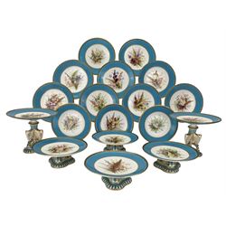 Victorian Royal Worcester porcelain dessert service circa 1877, each piece hand painted with a spray of wildflowers and fruit against a turquoise ground, within black painted Greek key and gilt borders, comprising two tall comports, the fluted stem with three receptacles shaped as winged insects on trefoil base, four short comports on trefoil base and twelve plates, pattern number B241 painted in iron red, puce and black painted factory marks (18)