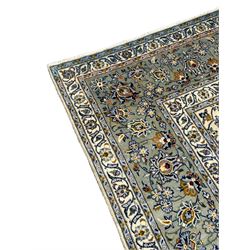Large Persian ivory ground carpet, the field decorated with interlacing and scrolled branches with stylised plant motifs, repeating border with floral design