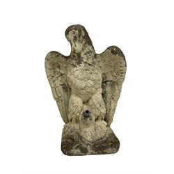 Composite stone garden ornament or water feature in the form of an eagle clutching a fish in its talons