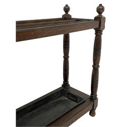Large late 19th century oak stick or umbrella stand, on turned supports with globular finials, with metal drip tray, on turned feet