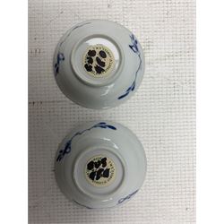Pair of Chinese blue and white Kangxi tea bowls and saucers decorated with seated and standing figures, two further plates painted with kneeling figures and miniature teapot of globular form with panelled exterior scenes together with small hexafoil vase of baluster form and cover (8)