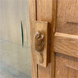 Beaverman - oak side cabinet, adzed rectangular top over two sliding glass doors and panelled door, the door handle carved with beaver signature, by Colin Almack, Sutton-under-Whitestone Cliffe, Thirsk