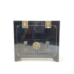 Chinese black lacquer low cabinet, with gilt painted detail, the top with two lift off lids revealing two storage compartments, double cupboard under, raised on stile supports W94cm, D47cm, H86cm