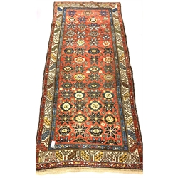 Caucasian runner rug, with stylised floral design on red field, enclosed by guarded border, 270cm x 115cm
