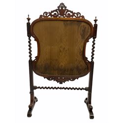 Victorian rosewood fire screen, pierced and scroll carved pediment centred by cartouch over glazed floral needlework upholstered screen in conforming scrolled frame, spiral turned and square moulded uprights united by spiral turned stretcher raised on scrolled sledge supports with applied turned roundels, W75cm
