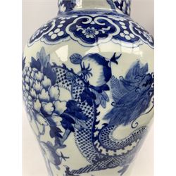 19th century Chinese blue and white vase and cover, of baluster painted with two coiling dragons, pomegranate branches and Peony, within a ruyi border, the decoration continues to the cover with Dog of Fo finial (not attached), H46cm 