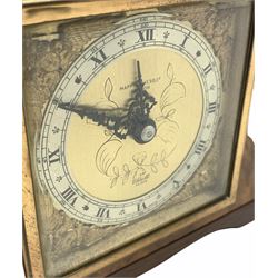 20th century figured walnut cased mantle clock retailed by Mappin & Webb, London, with inset eight-day Elliot timepiece movement and integral winding key, square brass finished dial with cherub head spandrels and silvered chapter ring, Roman numerals, Arabic five-minute numerals, half-hour markers, minute and quarter hour tracks, black Louis XV hands.