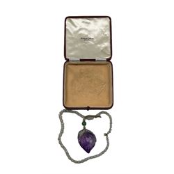 Chinese carved amethyst pendant in the form of a peach and rat, suspended on a beaded cord, together with an opalite and glass beaded bracelet, housed in an early 20th century Fortnum & Mason case 