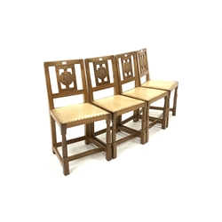 Set four 'Squirrelman' Yorkshire oak dining chairs, Yorkshire rose carved back panel over leather upholstered and studded seats, raised on octagonal turned supports united by 'H' stretcher, W45cm - Mouseman interest