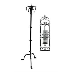 Vintage black painted wrought iron candlestand on tripod feet, H138cm, together with a similar style wirework wall sconce (2)