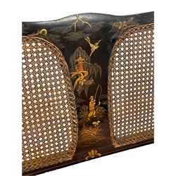 Early 20th century chinoiserie bergere settee, black lacquered with raised gilt decoration depicting figures and birds in landscape, caned back and sides, sprung seat upholstered in pink fabric with two cushions, on cabriole feet